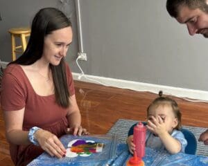 A woman and child playing with toys on the floor