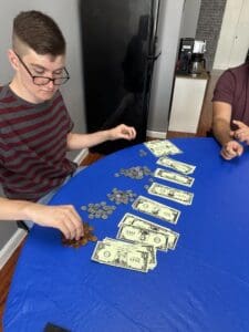 A man sitting at a table with money on it.